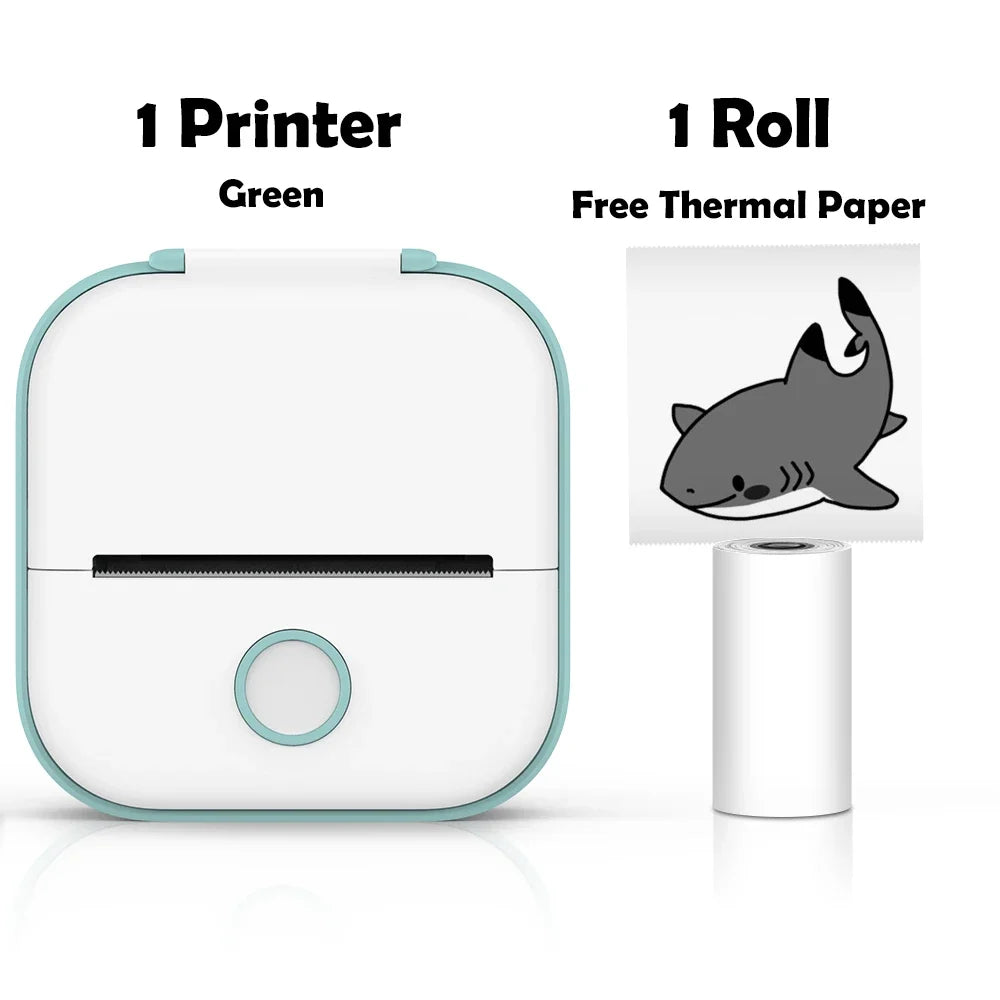 Small green printer with a roll of thermal paper featuring a shark design on a white background.